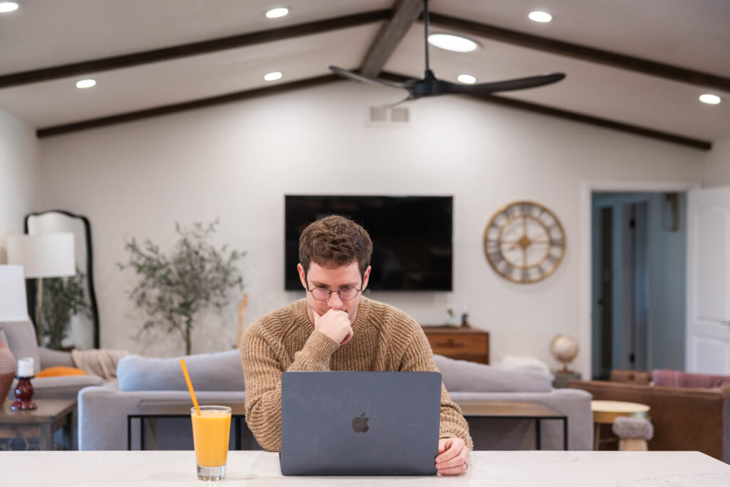 250219-Cole Sarah-044-web - Showit Figma Sites. Vs Showit: man working on a laptop.