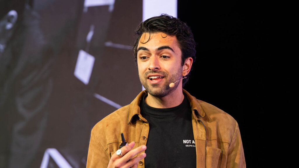 man speaking into a microphone from the article about Prepare For Your First Speaking Opportunity 